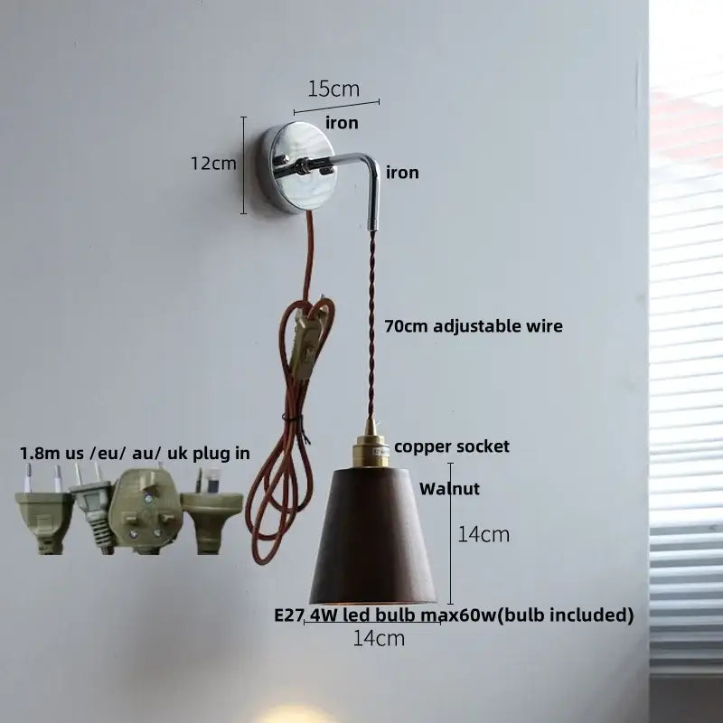 Japanese style black and brass wall lamp with pull chain features a polished iron bracket and adjustable copper socket with walnut shade