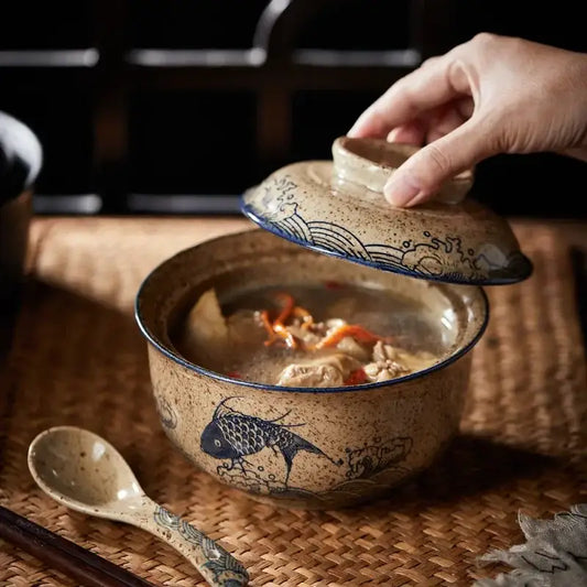 Earthenware ramen bowl with lid featuring blue fish wave motifs and speckled beige glaze japanese style decorbites