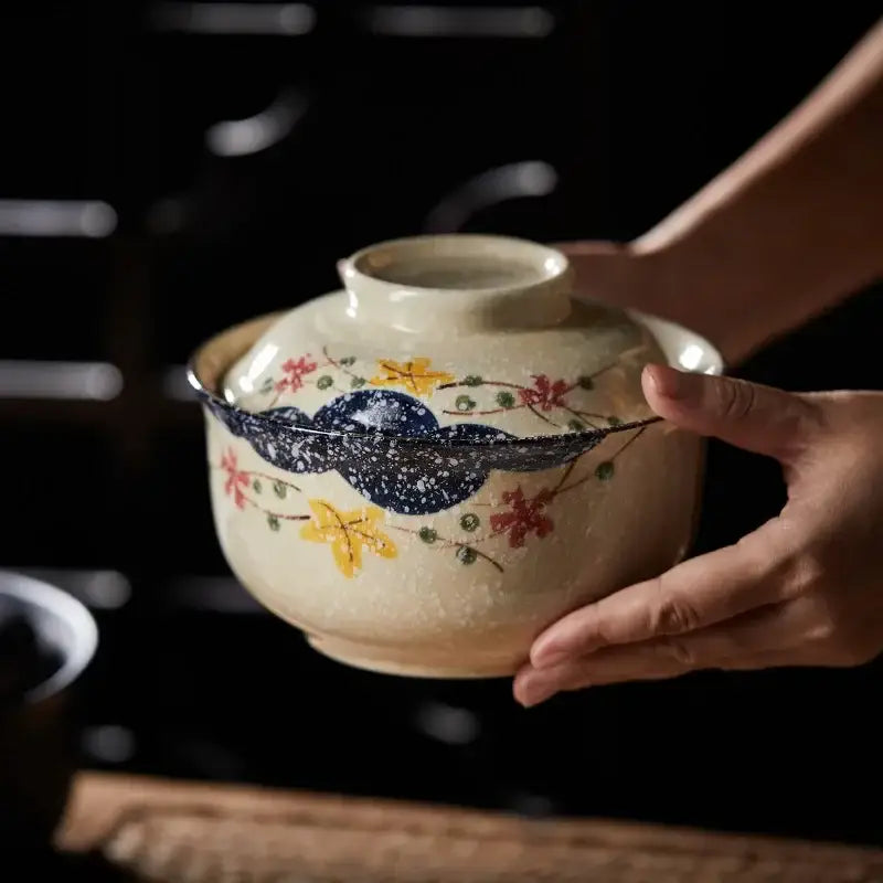 Hand-painted japanese style ceramic ramen bowl with cream base floral patterns and dark blue speckled band by decorbites japanese style