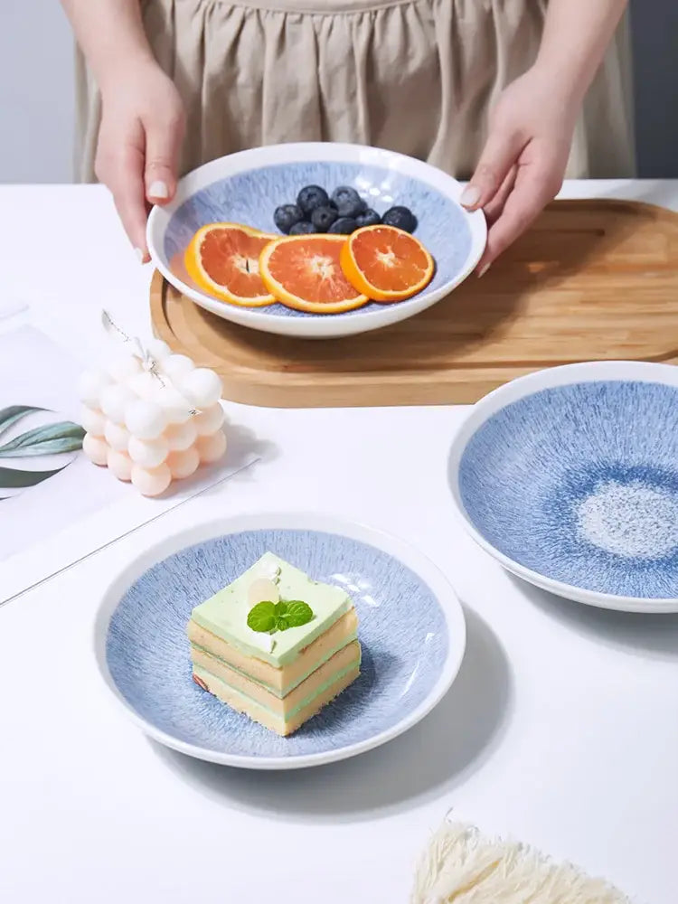 Japanese style blue and white ceramic deep dish bowl with textured speckled surface and white rim for dining use