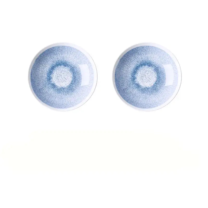 Two identical Japanese style blue and white ceramic deep dish bowls with a glossy light blue radial glaze pattern