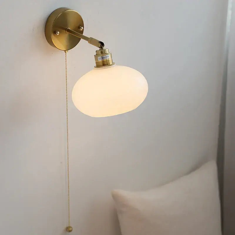 Gold-finished wall sconce with frosted white glass globe and adjustable arm decorbites japanese style led bedroom pull light