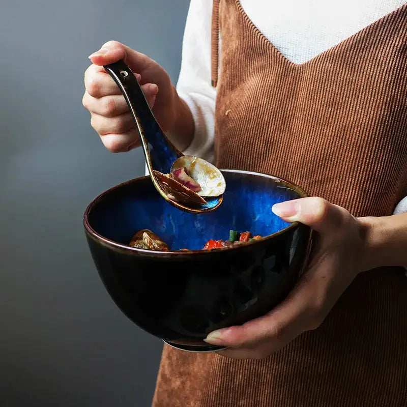 Deep blue ceramic salad bowl set featuring a glossy finish and textured rim with matching dark glaze spoon for decorbites ceramic salad use