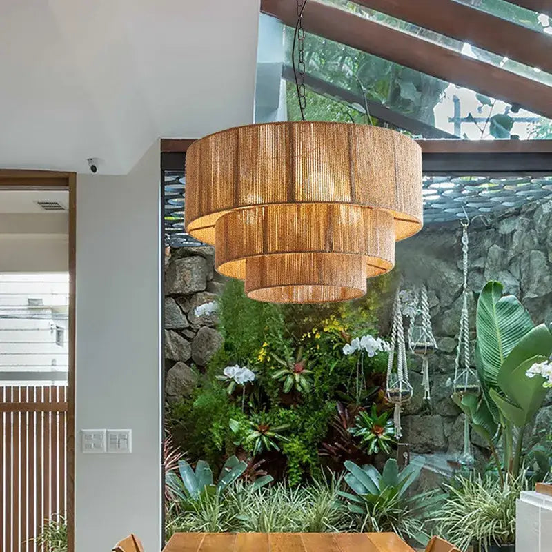 A warm-toned golden tiered hemp rope pendant light with woven natural fiber design for bedroom decorbites hemp rope