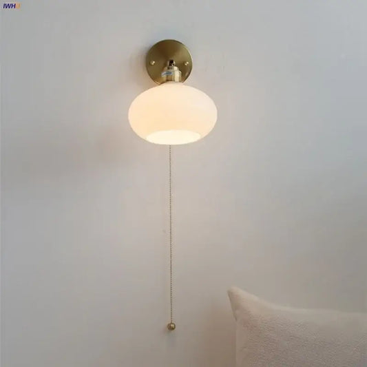 A warm frosted glass globe japanese style led brass wall sconce with pull chain for bedroom decorbites lighting