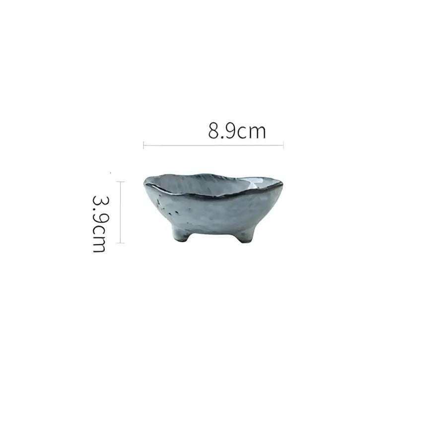 A small gray ceramic sauce dishes rice bowl with textured surface and three short feet for japanese style dining