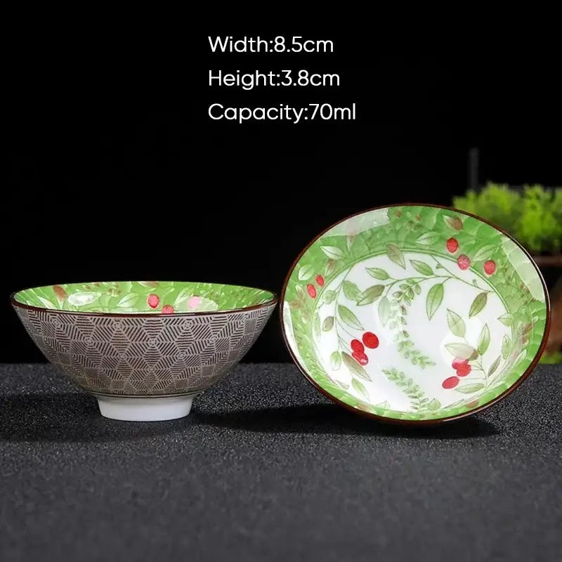 A japanese style multi color ceramic kung fu tea cup with green white botanical pattern red berries and brown rim