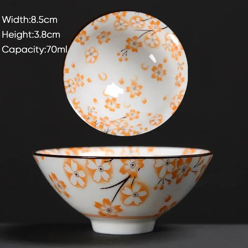 White ceramic kung fu tea cup with delicate orange and black cherry blossom pattern and brown rim by decorbites blue