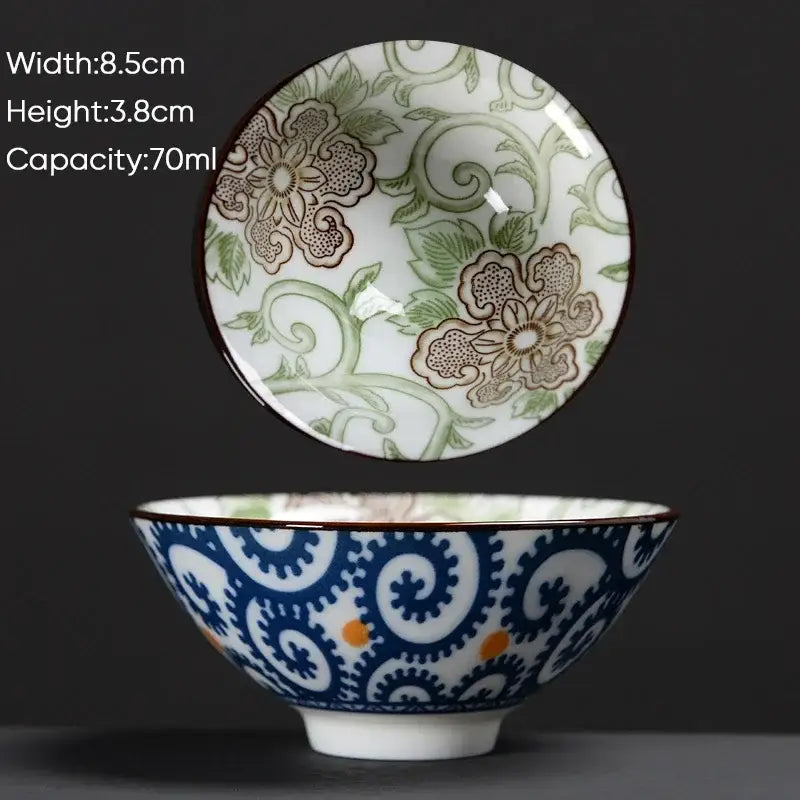 White ceramic kung fu tea cup with blue green floral pattern and orange accents in decorbites blue style