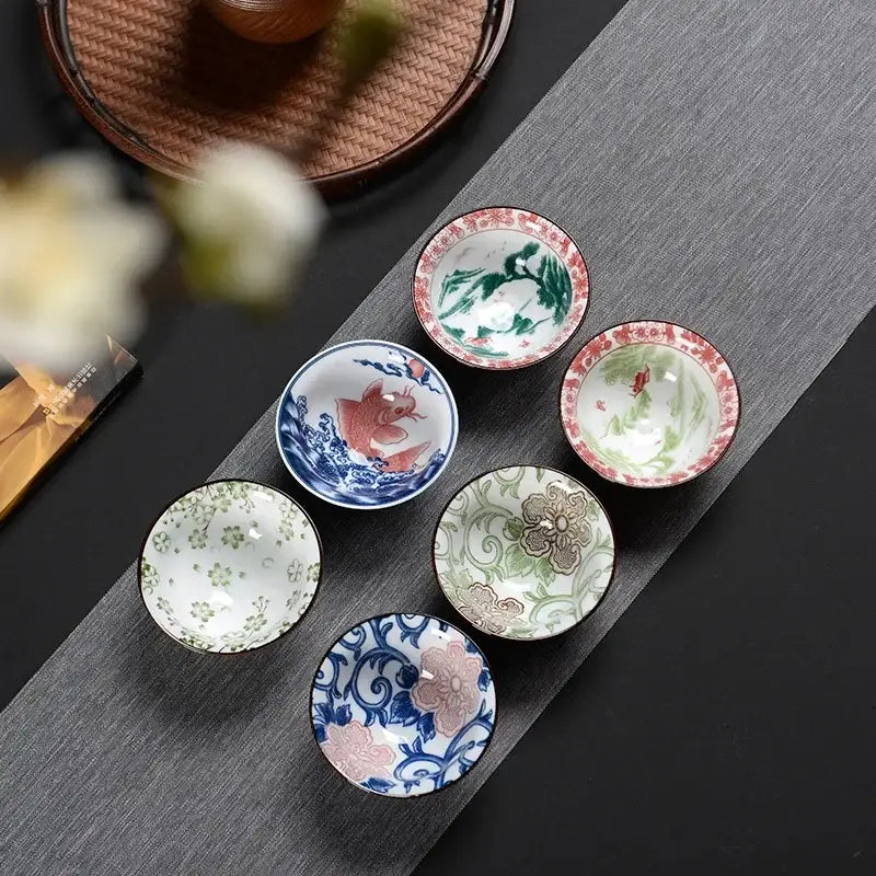 Six multicolor ceramic kung fu tea cups with intricate traditional designs in red blue green and pink by decorbites blue