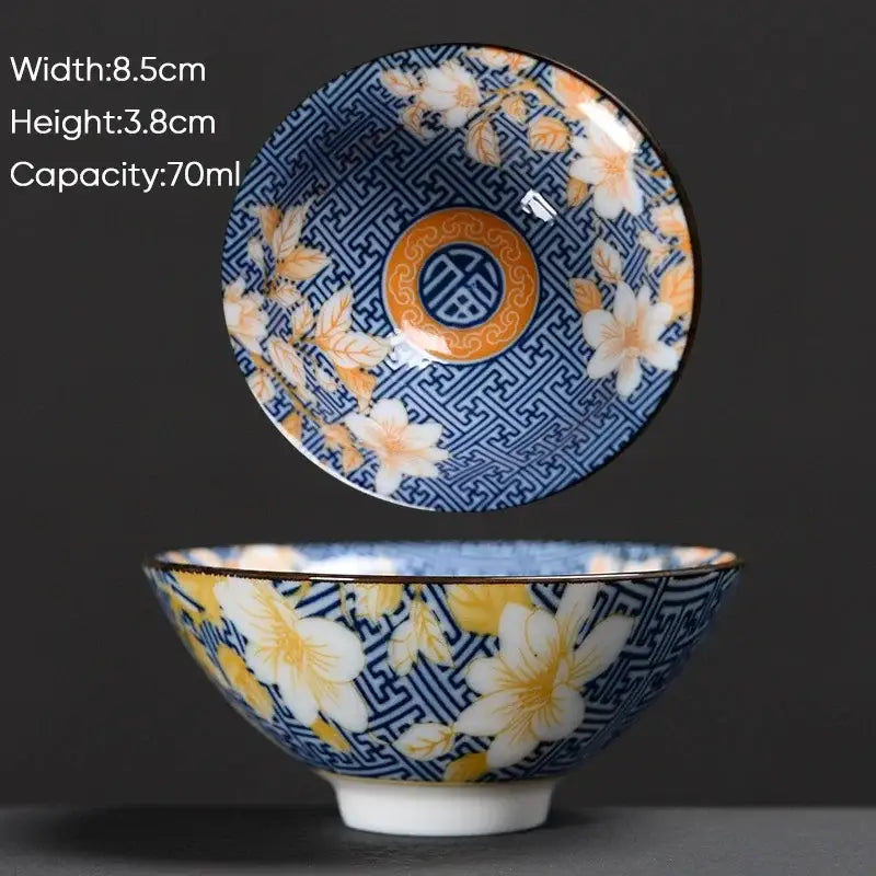 Traditional japanese style white ceramic kung fu tea cup with blue floral pattern and gold orange accents by decorbites blue