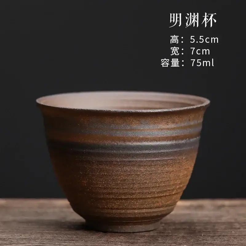 A rustic brown japanese style porcelain coffee tea cup with horizontal ridges and subtle amber tone variations