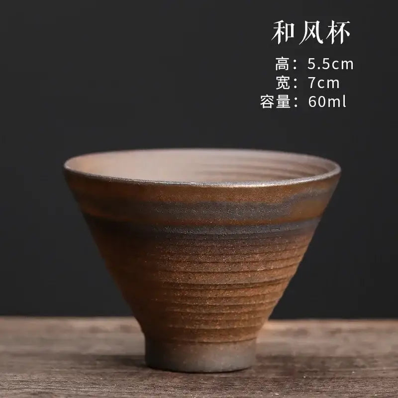 A rustic brown japanese style porcelain coffee tea cup with textured ribbed exterior and smooth lighter interior