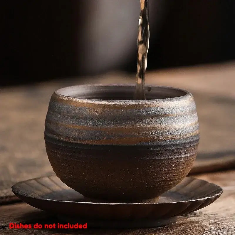 A rustic japanese style porcelain coffee tea cup in brown and gray glaze with horizontal ridges on a matching saucer