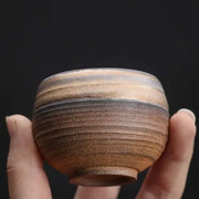Handcrafted japanese style porcelain coffee tea cup with earthy brown and gray glaze featuring subtle ridges