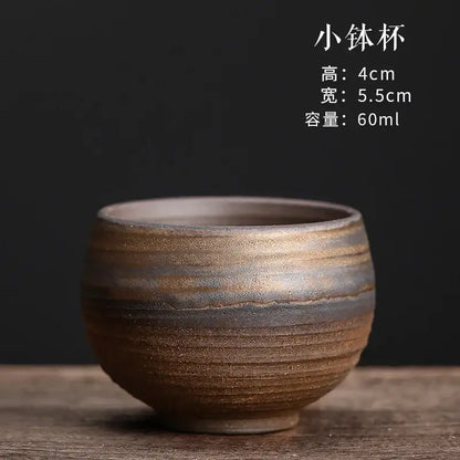 A rustic japanese style porcelain coffee tea cup with textured earthy brown and gray glaze for dining room use