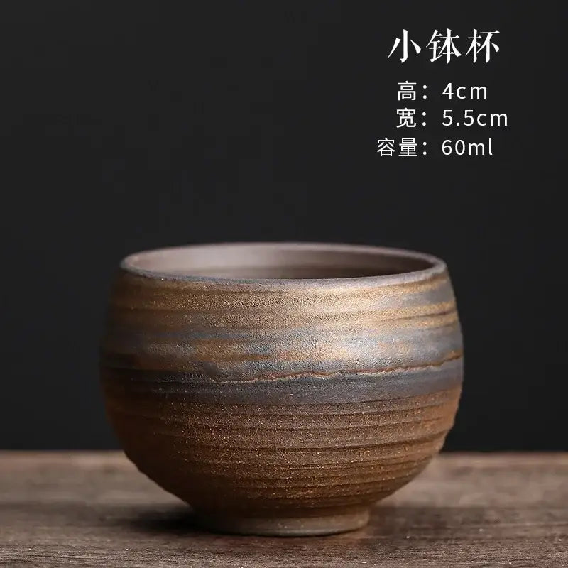 A rustic japanese style porcelain coffee tea cup with textured earthy brown and gray glaze for dining room use