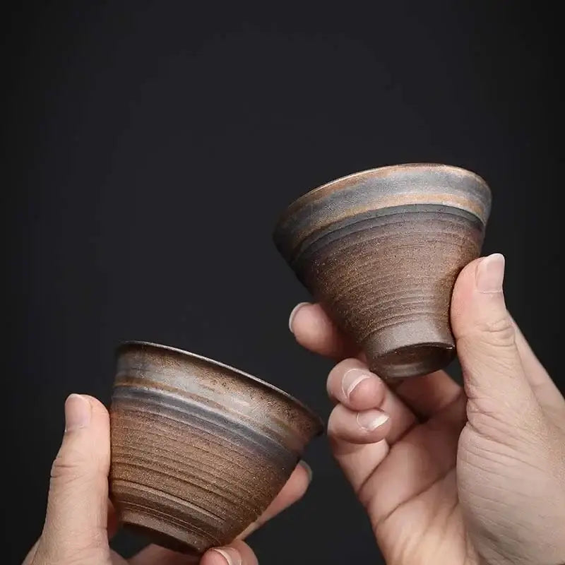 Two handcrafted japanese style porcelain coffee tea cups with rustic brown glaze and subtle horizontal ridges