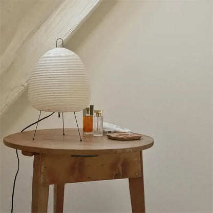 Off-white japanese style rice paper desk lamp with ribbed lantern design on slender metal stand for decorbites lighting