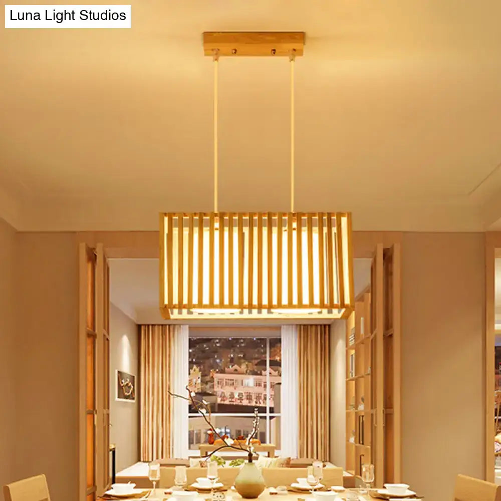 Rectangular rubber wood cuboid cage pendant light with vertical slats and warm golden glow for dining table lighting