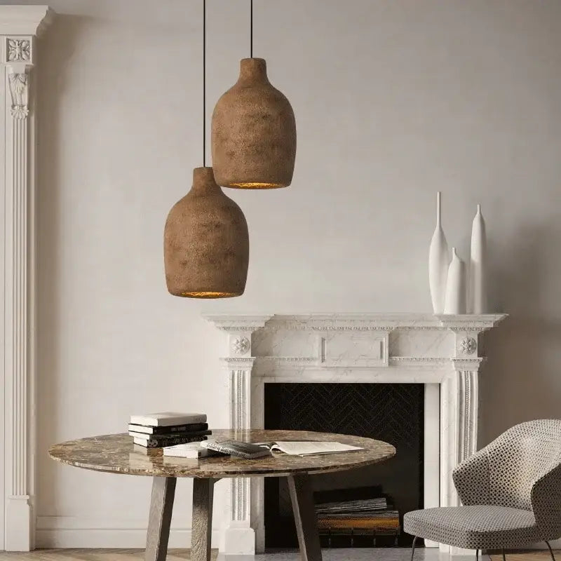 Two rustic earth-toned japanese style resin pendant lights with textured surfaces for dining room lighting
