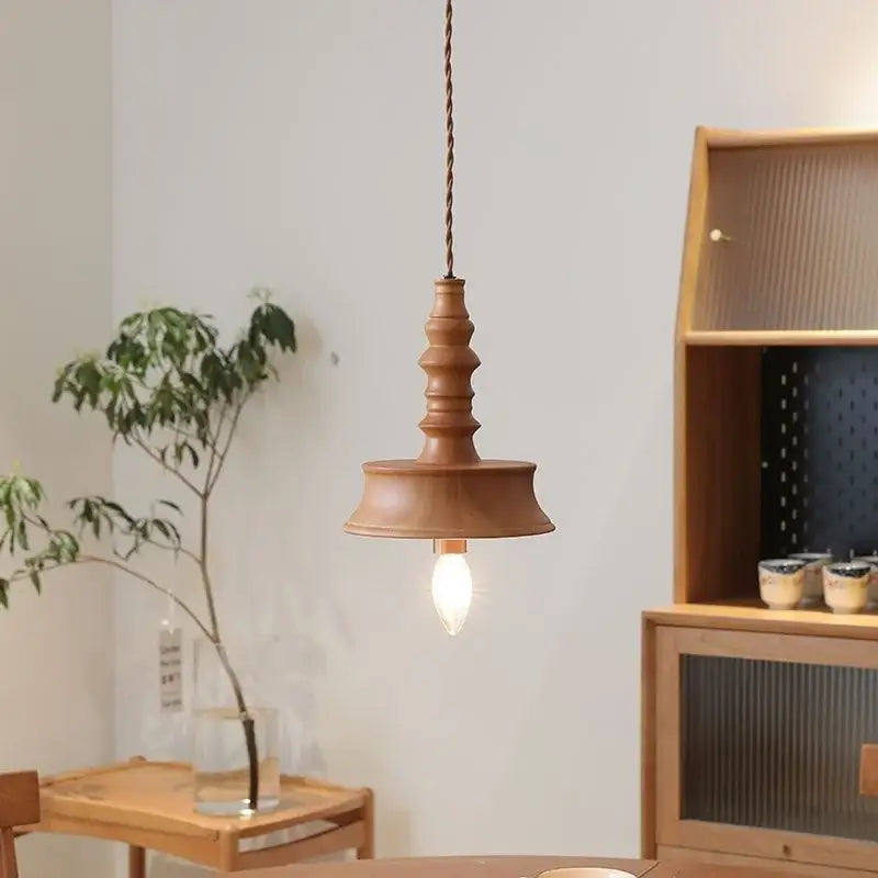 Japanese style terracotta ceramic pendant light with twisted copper chain and tiered flared design for dining room decorbites