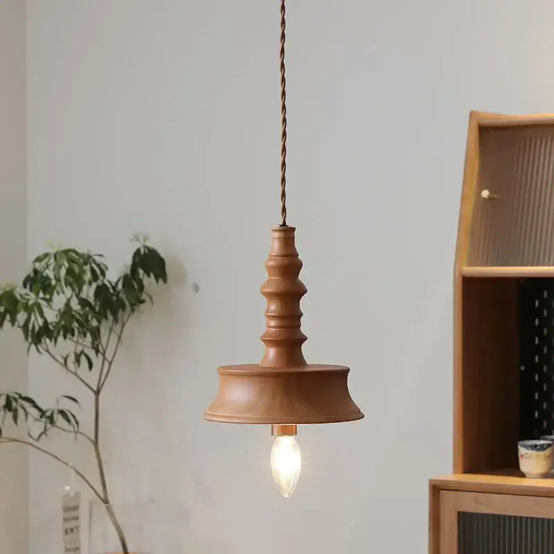 Japanese style terracotta ceramic pendant light with warm wood tones and twisted copper chain for dining room decorbites