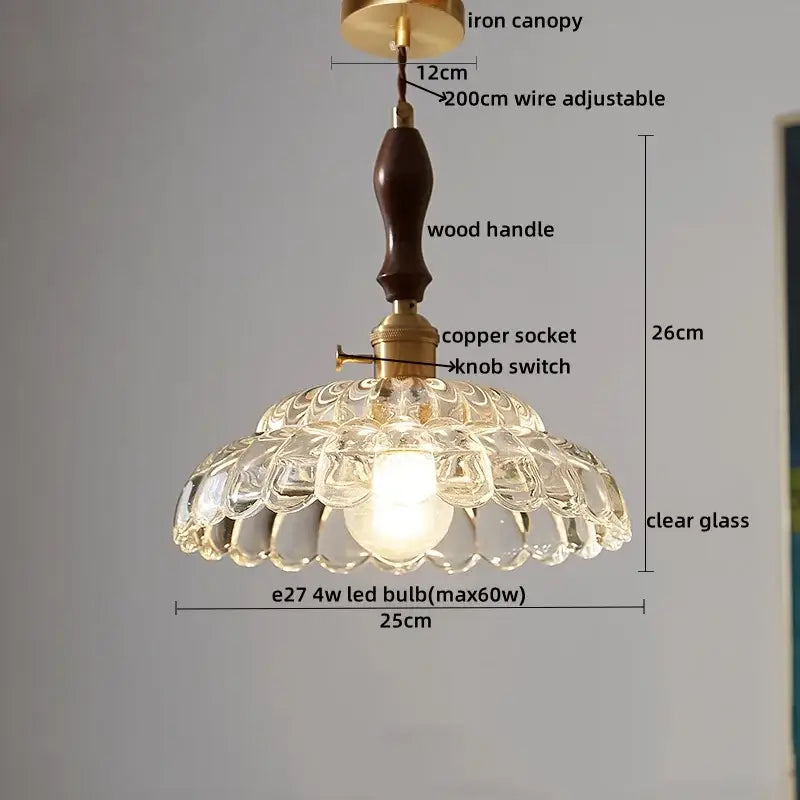 Japanese style clear glass pendant lamp with textured petal cutouts, wood trim, and brass fittings for dining room decorbites