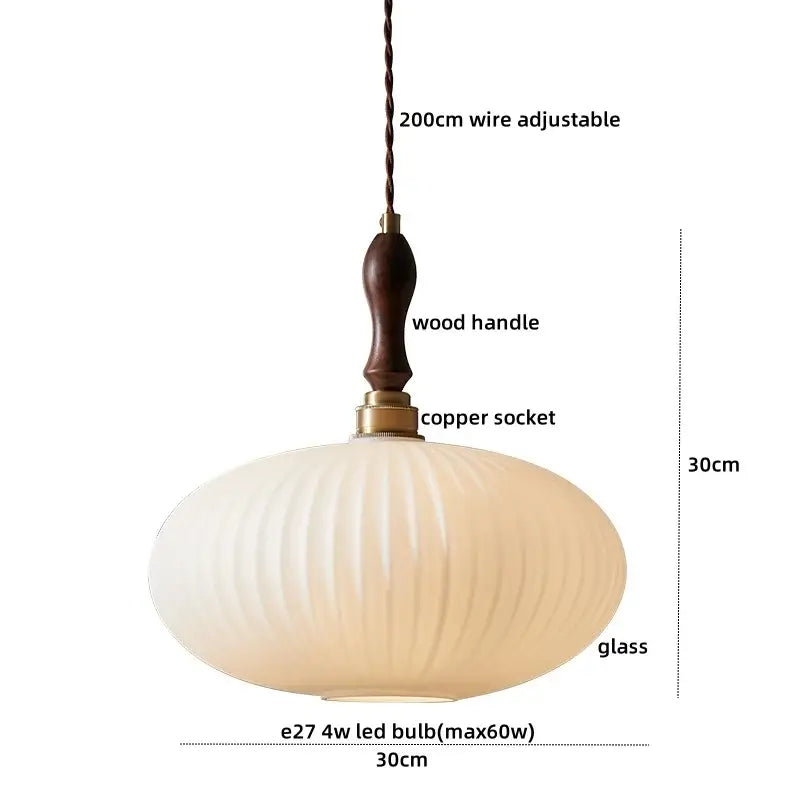 Cream-colored ribbed clear glass pendant lamp with dark wood handle and copper socket for dining room decorbites clear glass