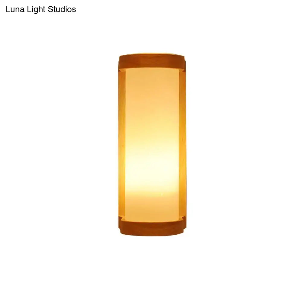 Japanese style wall sconce lamp with warm amber glass diffuser and dark wooden accents for bedroom lighting
