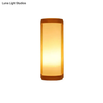 Japanese style wall sconce lamp with warm amber glass diffuser and dark wooden accents for bedroom lighting