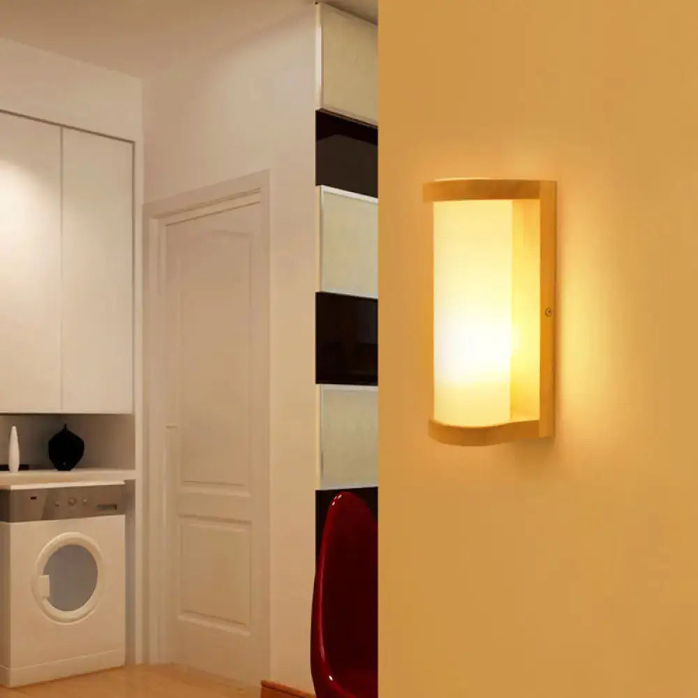 Japanese style wall sconce lamp with warm-toned wooden frame and frosted white glass diffuser for bedroom lighting