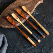 Set of four japanese style wooden spoons with woven handle wraps in natural and dark wood tones for kitchen use