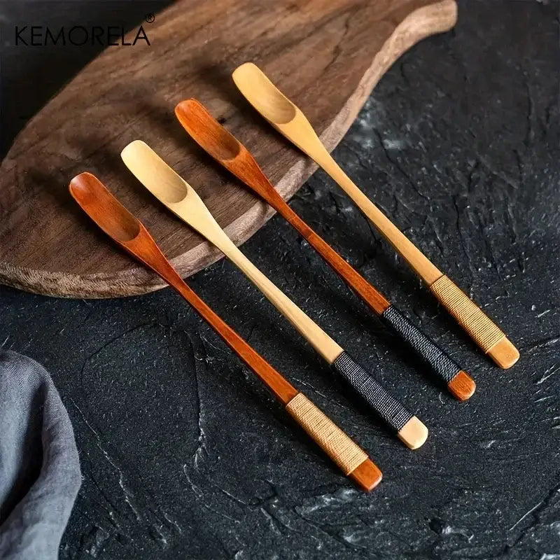Set of four japanese style wooden spoons with woven handle wraps in natural and dark wood tones for kitchen use