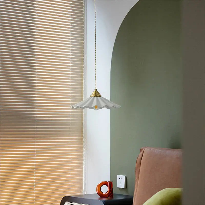 A delicate white ceramic led pendant light with a fluted shade and brass fixture for kitchen decorbites ceramic led