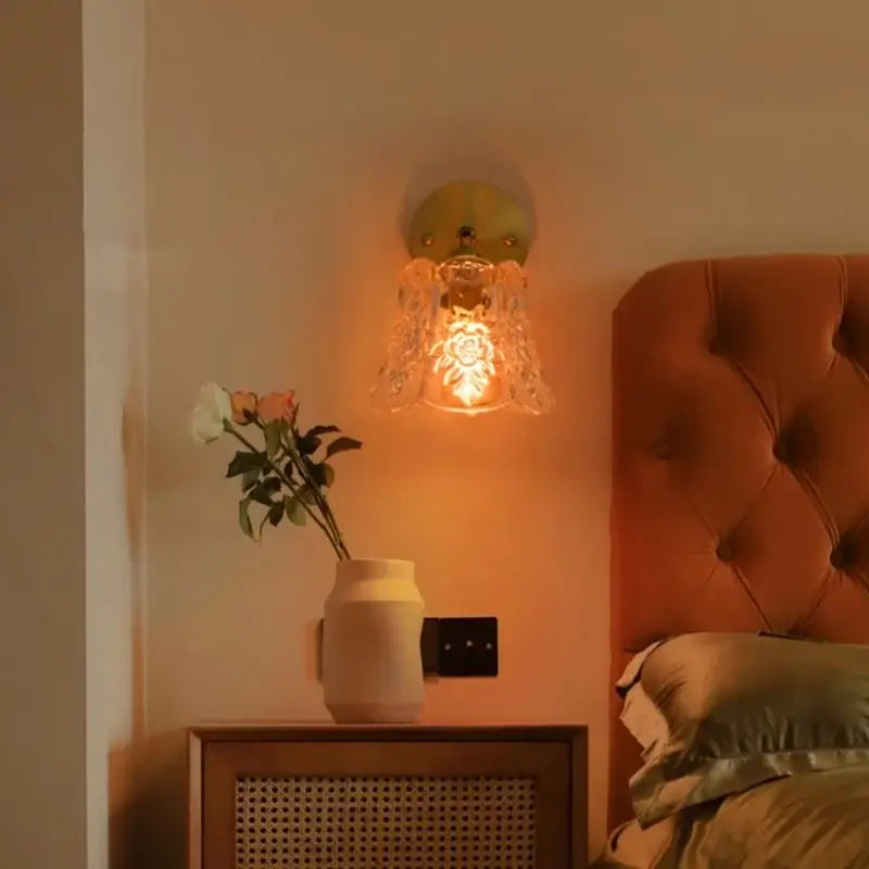A warm-toned japanese vintage gold bell glass led wall lamp with greenish brass backplate and floral etched shade