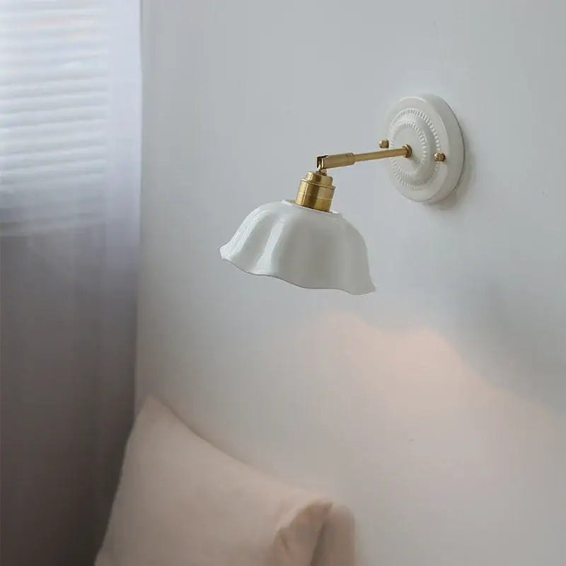 Japanese vintage white ceramic led wall sconce with gold-toned metal arm and decorative base for bedroom decorbites ceramic led wall