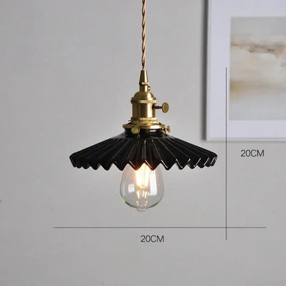 Black ceramic pendant light with brass socket and twisted cord paired with polished copper finish kitchen lighting