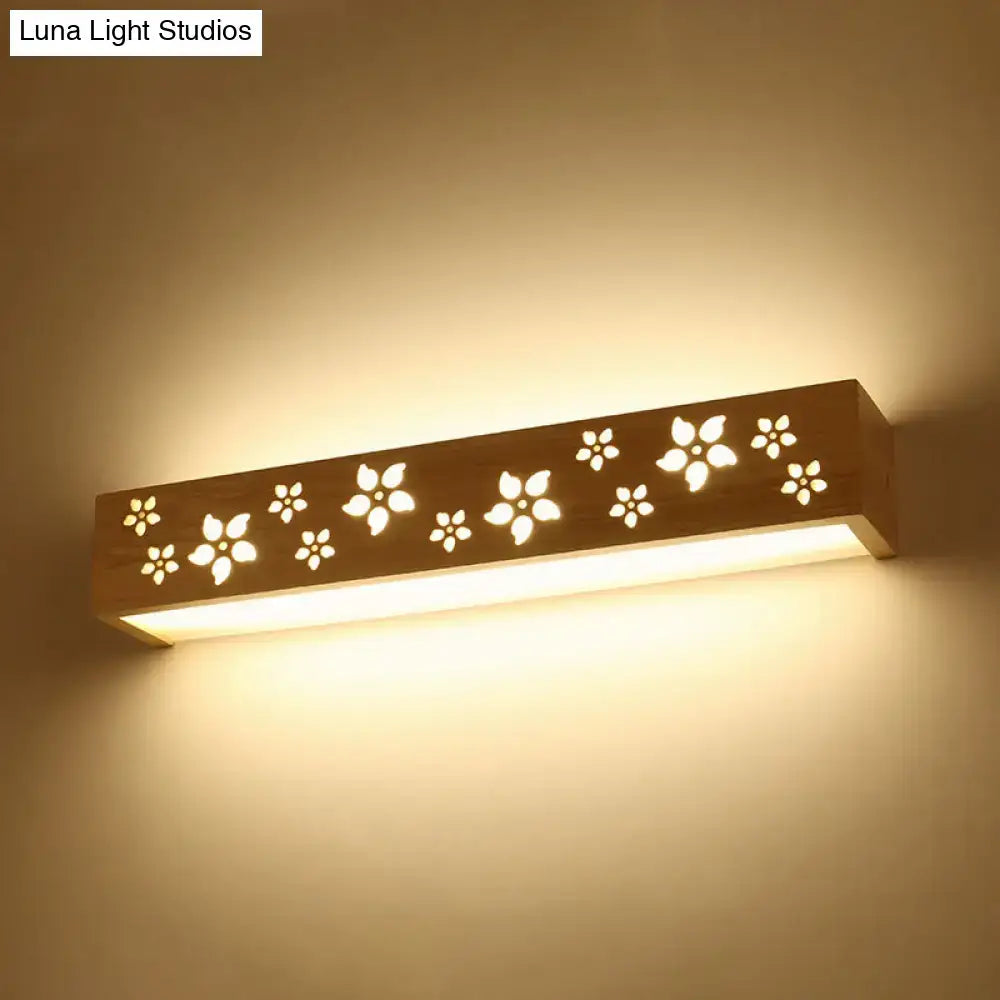 Japanese wooden floral wall lamp with warm tones and delicate cutouts designed as a bedroom led sconce with shelf