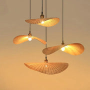 Four warm-toned woven decorbites bamboo chandelier pendant lights with brass accents for living room lighting
