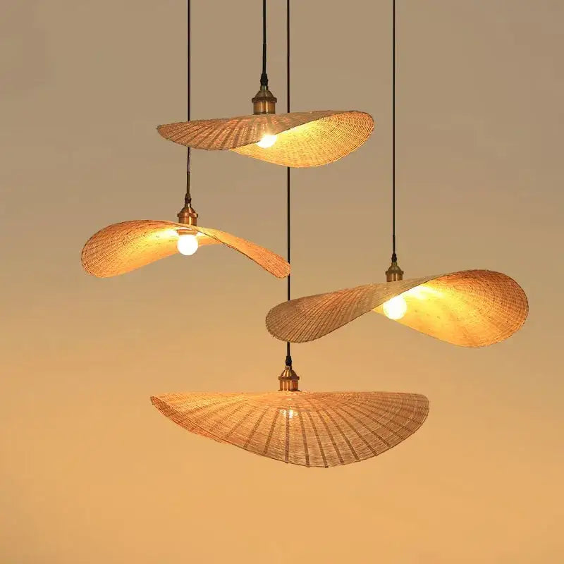 Four warm-toned woven decorbites bamboo chandelier pendant lights with brass accents for living room lighting