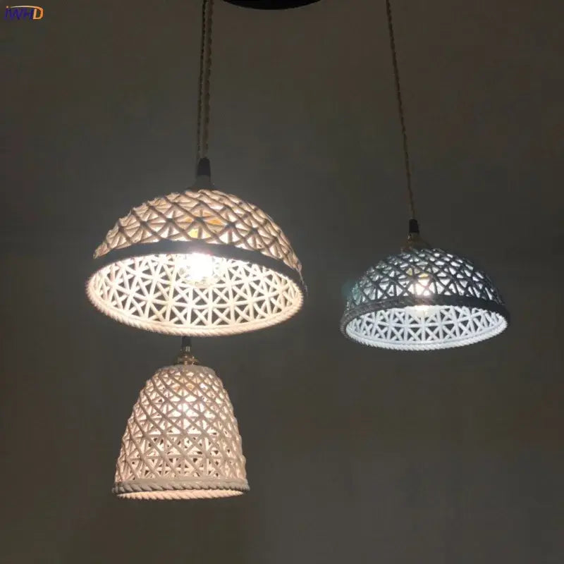 Three white Japanese woven gray and blue decorbites ceramic led pendant lights with geometric pattern hang in dining room