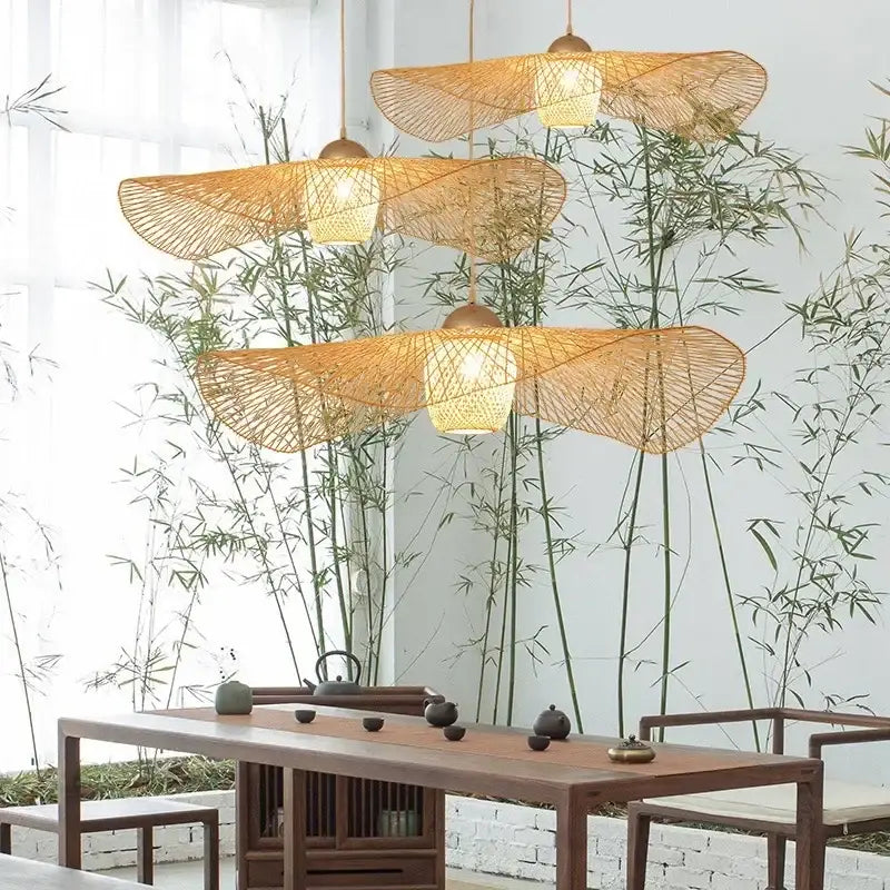 Three hanging pendant chandelier lights with wide woven bamboo shades and warm brass decorbites bamboo pendant fixture