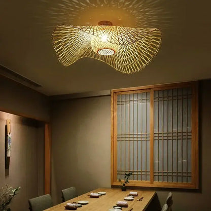 Japanese woven wave bamboo pendant chandelier with intricate radial pattern and warm golden glow for dining room decorbites bamboo pendant