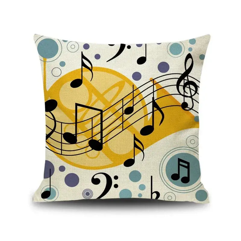 A cream linen square cushion cover with vibrant black letter notes piano graphic accented by yellow swirls and teal polka dots