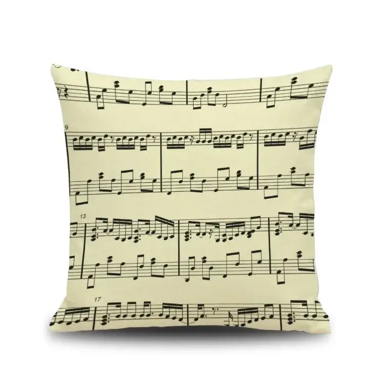 Cream-colored linen throw pillow featuring black notes piano graphic for living room decorbites letter notes decor