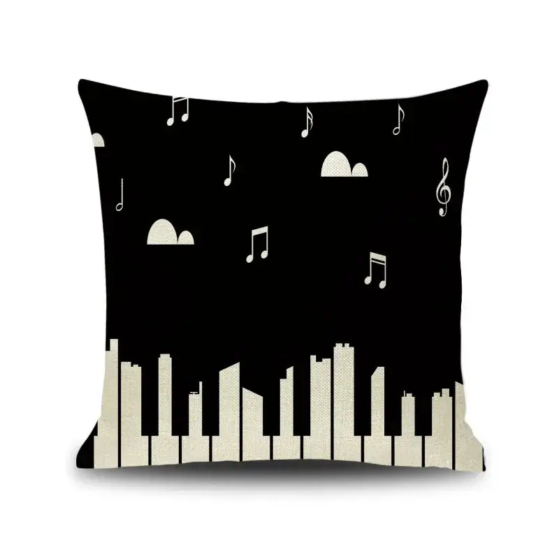 Black linen throw pillow with white musical note and treble clef pattern over off-white piano key skyline decorbites letter notes