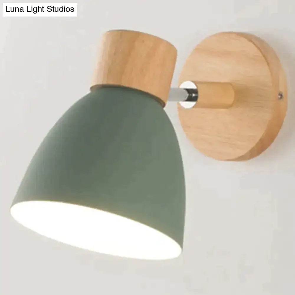 A joan wooden reading wall lamp with a matte sage green conical shade and natural wood accents for bedroom lighting