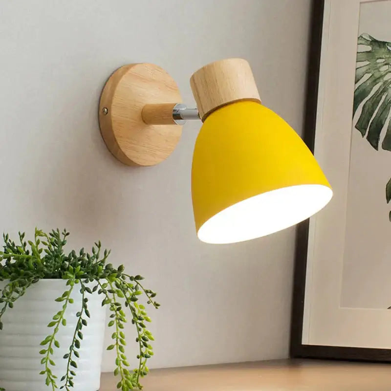 Joan wooden reading wall lamp with yellow conical lampshade natural wood base and metal arm mounted on wall