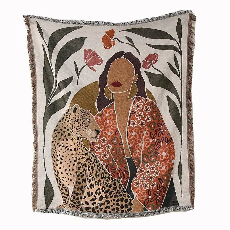 A cream and pink woven leopard print throw blanket featuring a woman in an orange floral robe with jungle decorbites design
